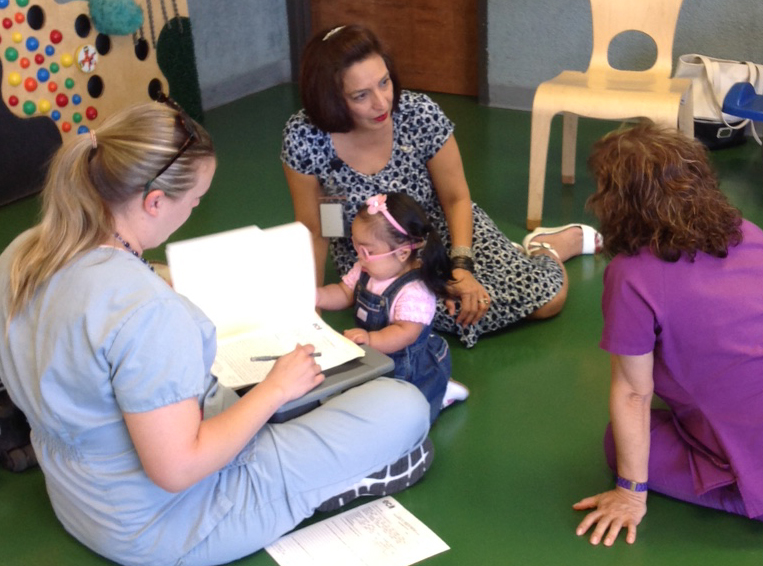 ECI staff members interviewing mother with toddler