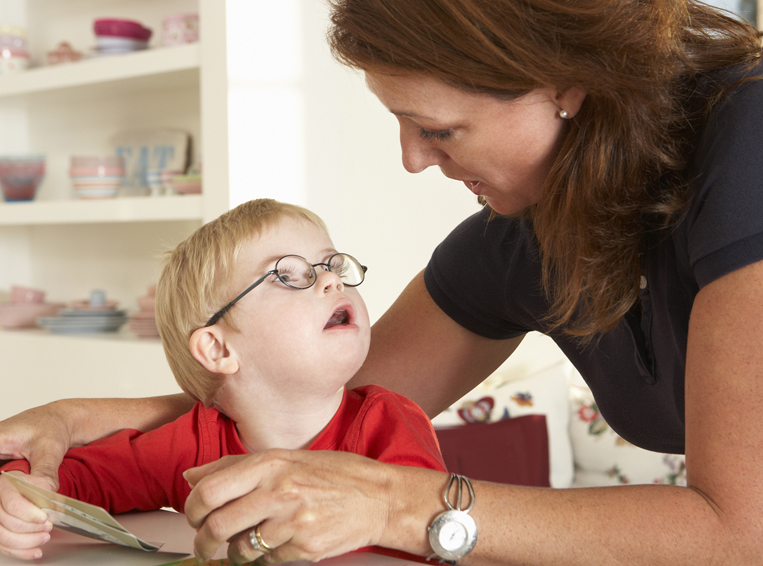 Mom helping a toddler with glasses