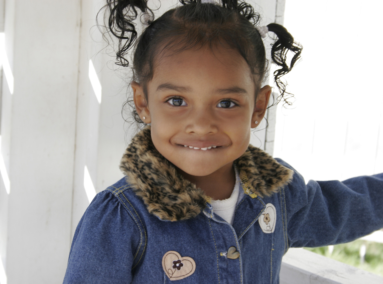 Toddler girl with jean jacket smiling